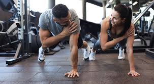Image of man and woman doing Cardio Eccles to tone their arms. 